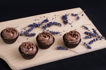 Chocolate Cupcakes on a wooden chopping board and lavender flowers