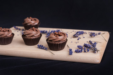 Chocolate Cupcakes on a wooden chopping board and lavender flowers