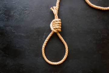 running knot of rope on a black background. Concept stop suicide