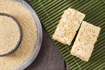 Amaranth seeds and energy bars on wood