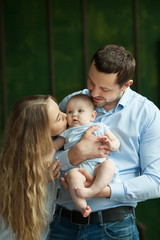 Portrait of a young family with a little daughter a girl in her arms