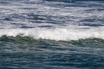 Naklejka na ściany i meble Close up Ocean Waves Breaking on Coastal Shoreline