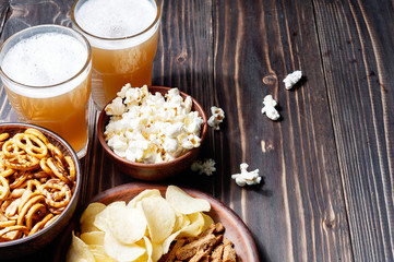 Beer with pretzels, saltsticks and potato chips. Viewed from above.