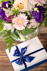 Blue gift box with beautiful bouquet of flowers