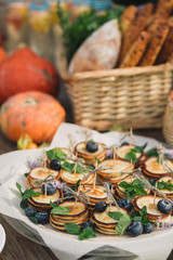Canape of pancakes with blueberries