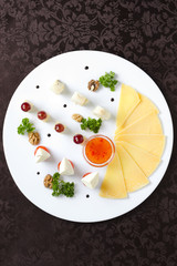 Assorted of different cheeses on a white plate