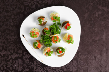Fish canapes on a white plate