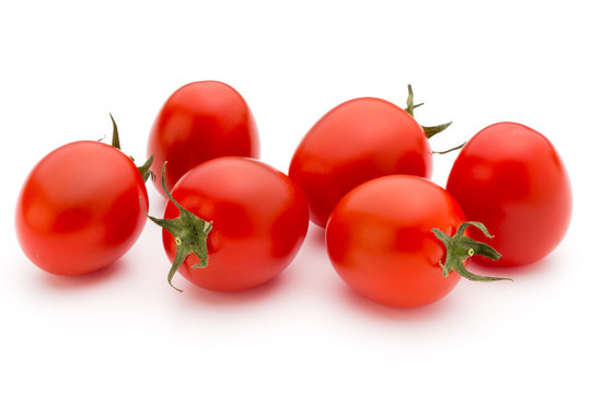 Small plum tomatoes on a white background.