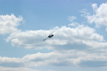 helicopter fly at cloudy sky background