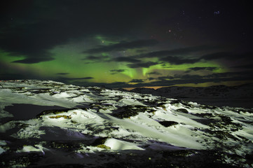 Fototapeta na wymiar Aurora borealis and a mountain landscape 