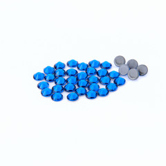 Precious sparkling rhinestones Capri blue colors on a white background.