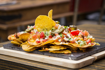 Plate of nachos flavored with vegetables of different flavors and textures
