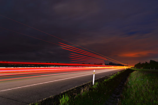 Long-exposure sunset over a highway