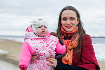 Happy mother walks with two daughters