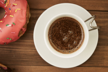 donuts and coffee on a wooden table