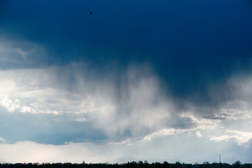 Rain cloud, close-up, rainstorm against the background of the summer sky. Texture. The rain comes from the cloud.