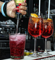 Woman hands making cocktail on bar counter