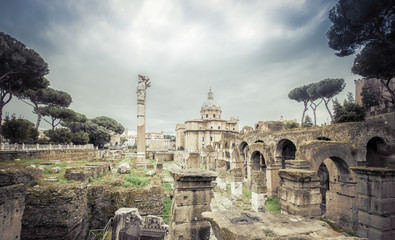 Roman ruins in Rome, Forum. Ancient ruins of the Romanum Forum. Ruins of Septimius Severus Arch and...