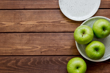 Healthy green food with apples on plates wooden background top view mock up