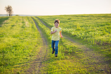 Little boy running on rural road