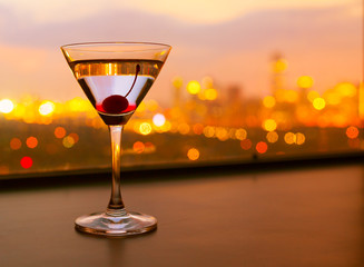 Martini glass and a beautiful city view. 