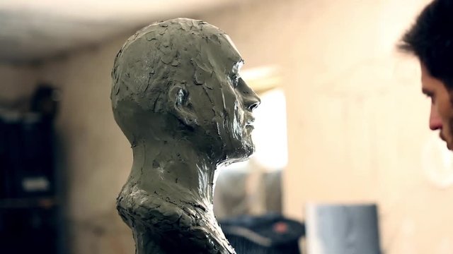 Sculptor is working on the creation of a monument
