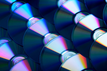 Compact discs background. Several cd dvd blu-ray discs. Optical recordable or rewritable digital...
