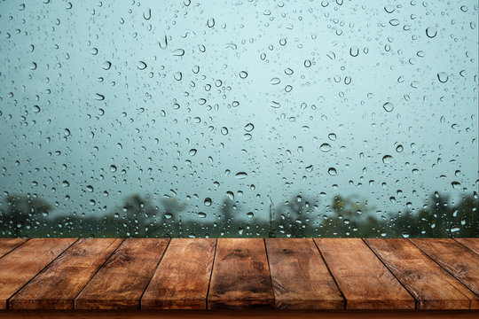 Wood Table With Rain Water Drop On Window.