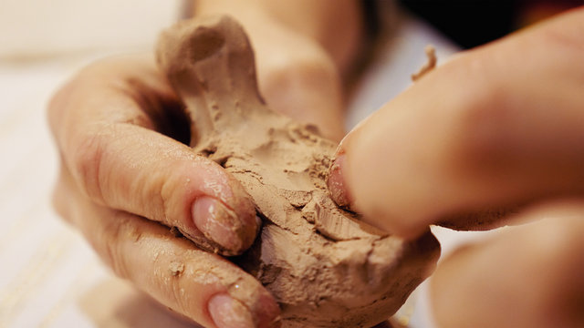 Female sculptor is modeling clay figurine or creating pottery ceramics statuette. Art and handicraft modelling creation.