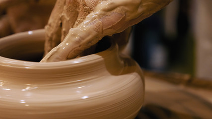 Potter is making clay pot bowl or vase ceramics porcelain on the potter's wheel. Creating pottery...