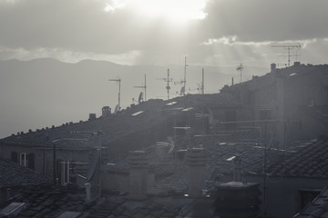 TV aerials on the roofs of the houses of the famous city of Volterra in Tuscany during a sunset