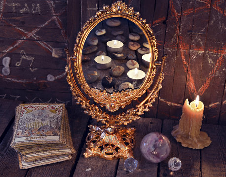 Magic mirror with Tarot cards and mystic objects. Divination rite