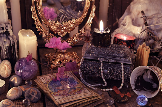 Divination rite with the tarot cards, flowers and mystic objects