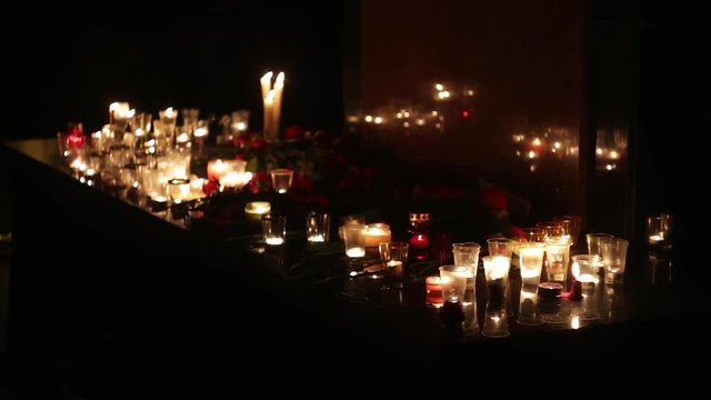 The scene of the terrorist attack in the US and Europe. People bring a large number of flowers and candles to the place of death. Memorial in honor of those who perished from military operations and