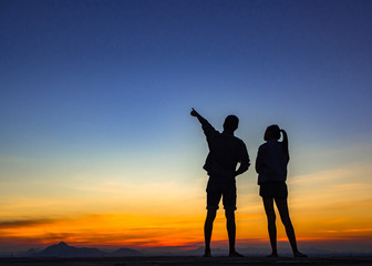 Silhouette of couple love outside sunset