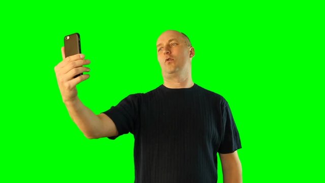 Adult man make photo with smartphone.