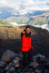 A man makes selfie against the background of a mountain in the region of Elbrus