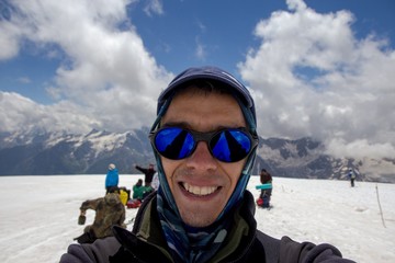 Fototapeta na wymiar A man makes selfie in yhe slope of Elbrus mountain