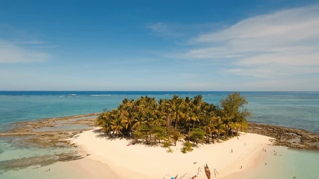 Aerial view of beautiful tropical island Guyam with white sand beach. View of a nice tropical beach from the air. Seascape: Ocean and beautiful beach paradise. Philippines. 4K video. Travel concept
