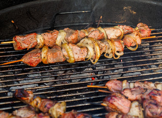 Shish kebabs on skeweres are cooked on charcoal grill
