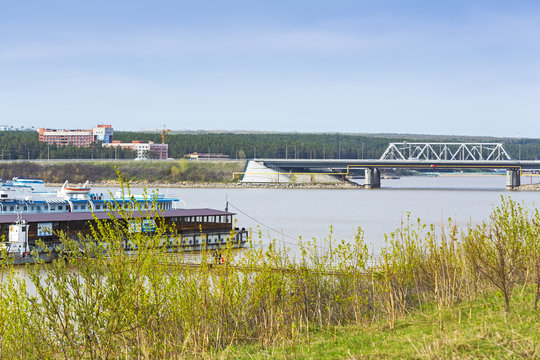 View of the pier and the bridge over the river. The River Berd, Berdsk, Siberia, Russia