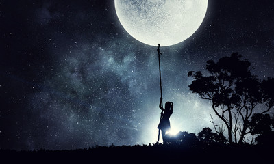 Kid girl catching moon