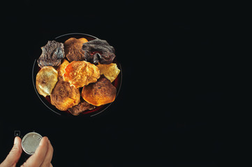 Vegetable chips lie on an electric stove and cook. Preparation of vegetable and potato chips