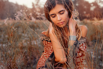close up of beautiful young woman at sunset