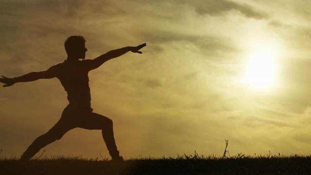 Male silhouette doing yoga warrior pose and back bend