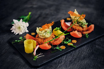 Seafood snacks with tomatoes.