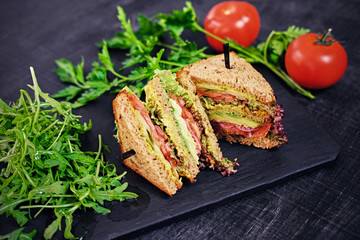 Vegetarian sandwich with salad and tomatoes.