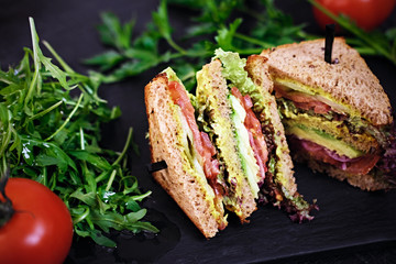 Vegetarian sandwich with salad and tomatoes.