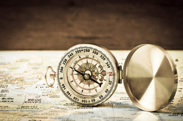 Compass on world map.