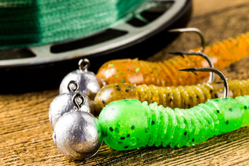 jig fishing lures on a brown wooden table